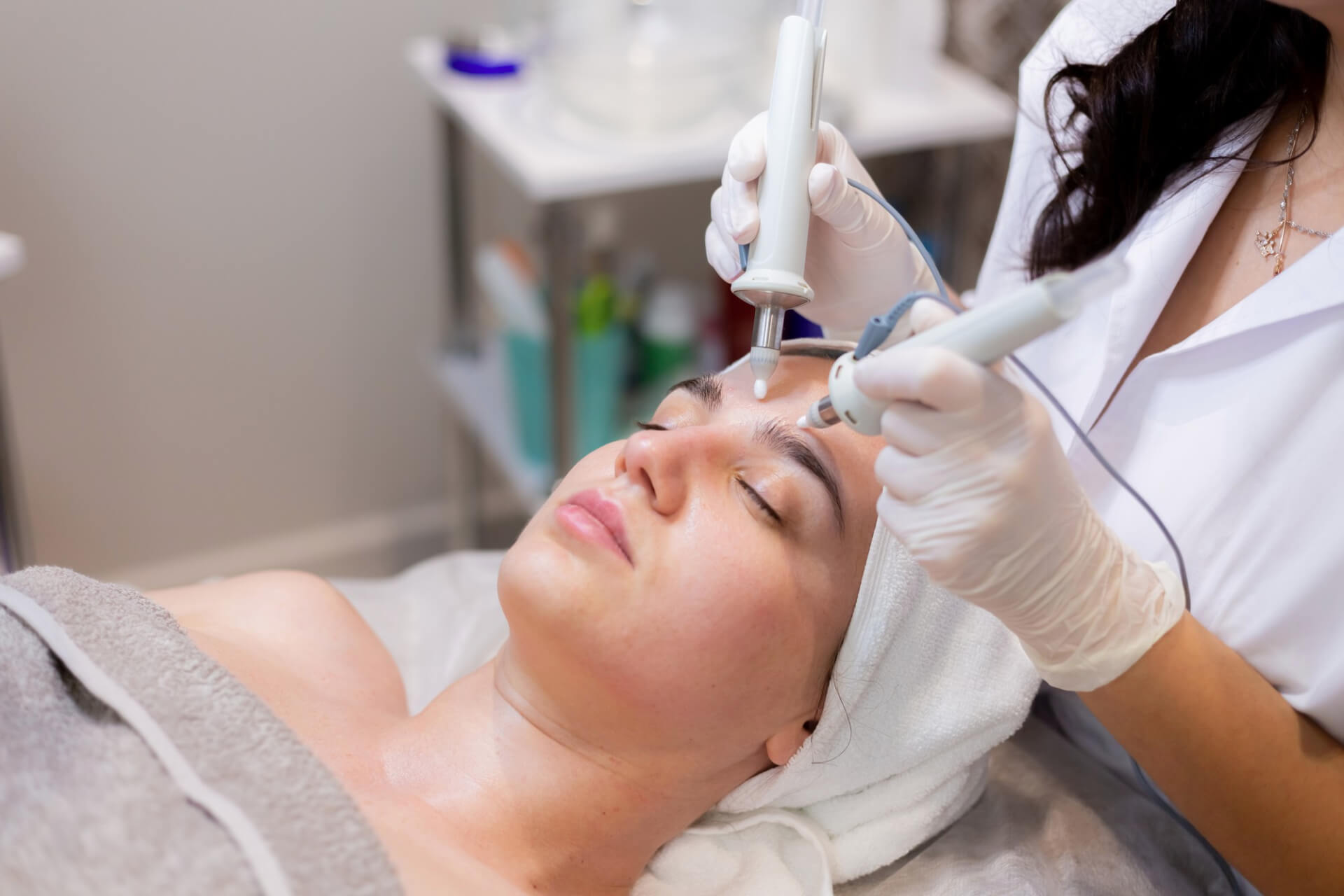 young beautiful girl lies on the beautician's table and receives procedures